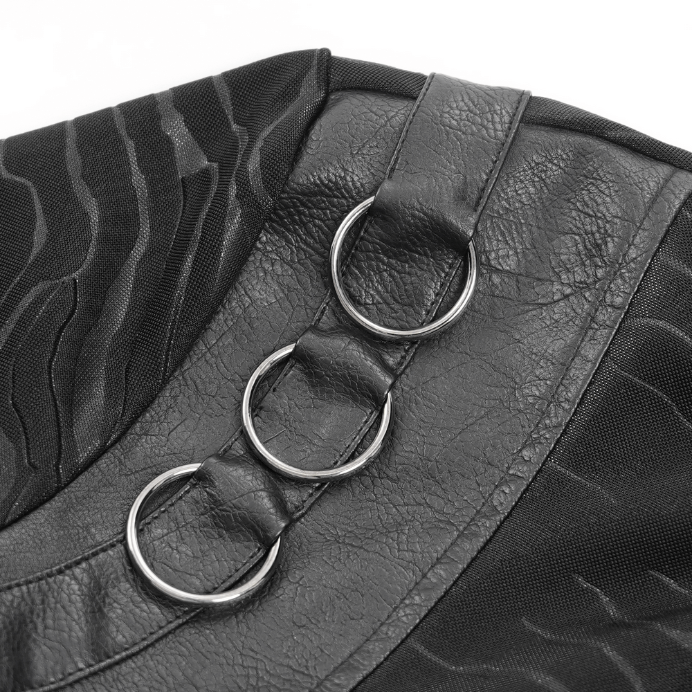 Close-up of high-collar black top showcasing faux leather ring accents and textured fabric design.