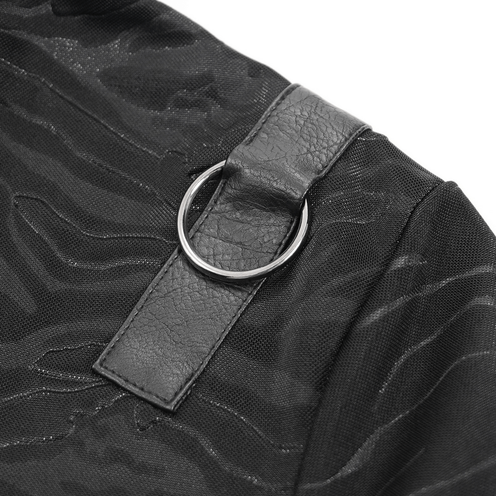 Close-up of faux leather ring accent on a stylish black gothic top, showcasing textured fabric and edgy design.