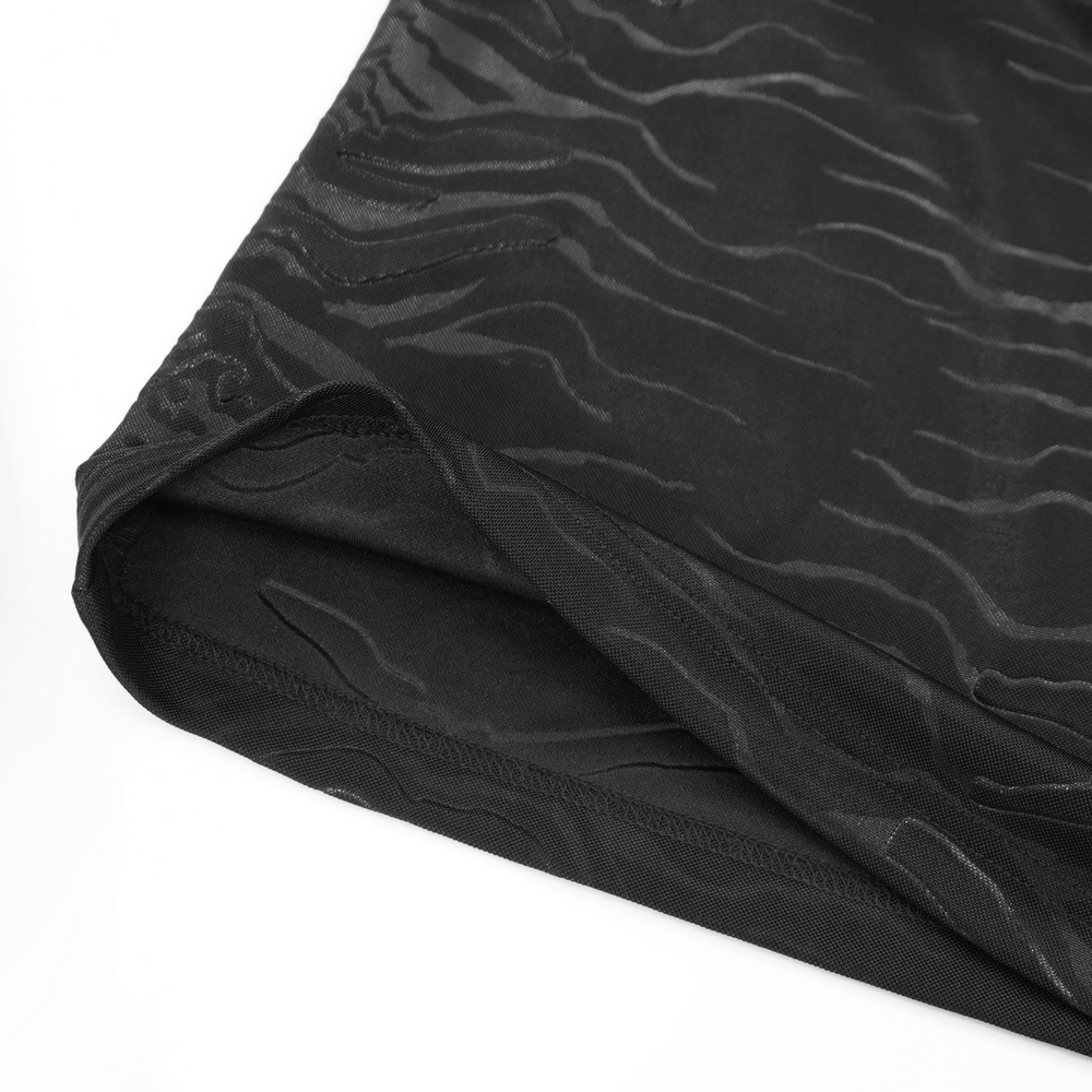 Close-up of the textured pattern on the hem of a stylish men's gothic black top with intricate design details.