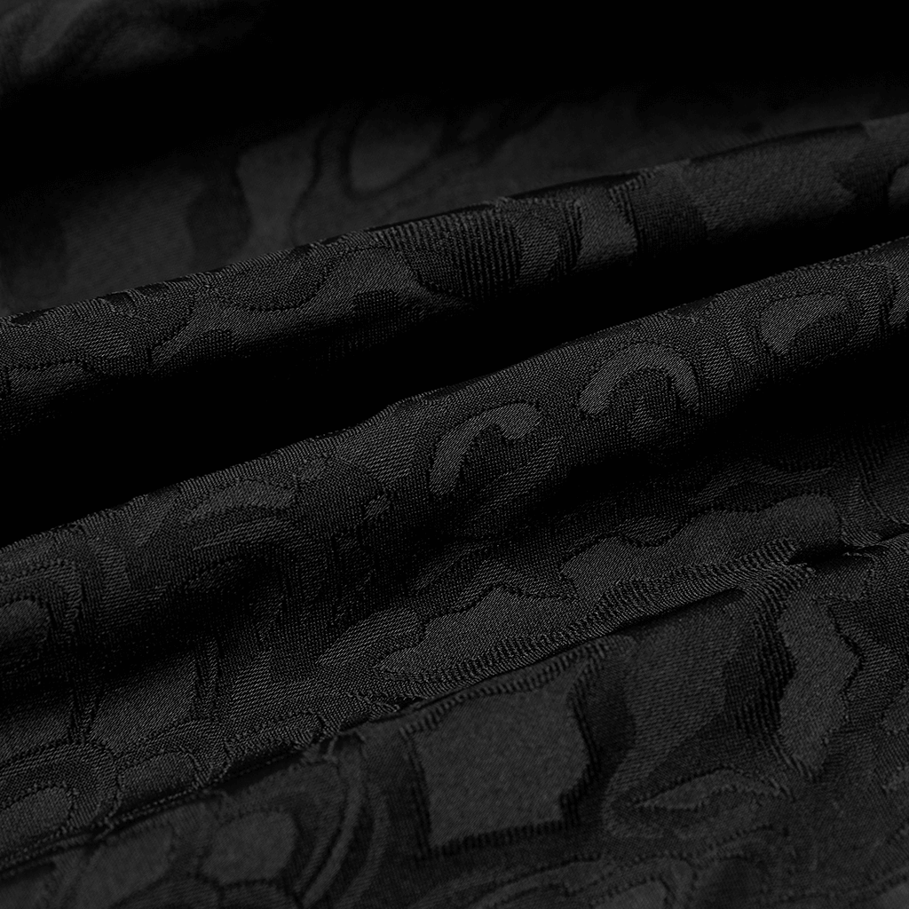 Close-up of luxurious black gothic jacquard fabric, showcasing elegant texture and intricate design.