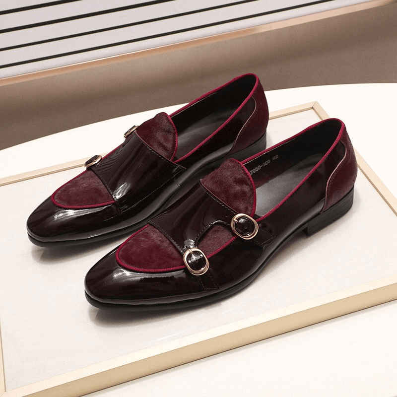 Stylish men's patent leather loafers in burgundy with double buckle design, showcasing a unique casual yet sophisticated look.