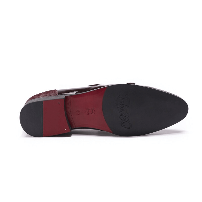 Sleek underside of stylish men's patent leather loafers with double buckle design.