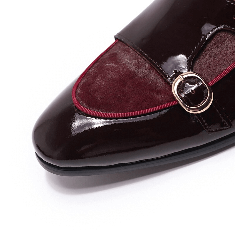 Stylish men's patent leather loafer featuring a double buckle design and sleek burgundy accents.
