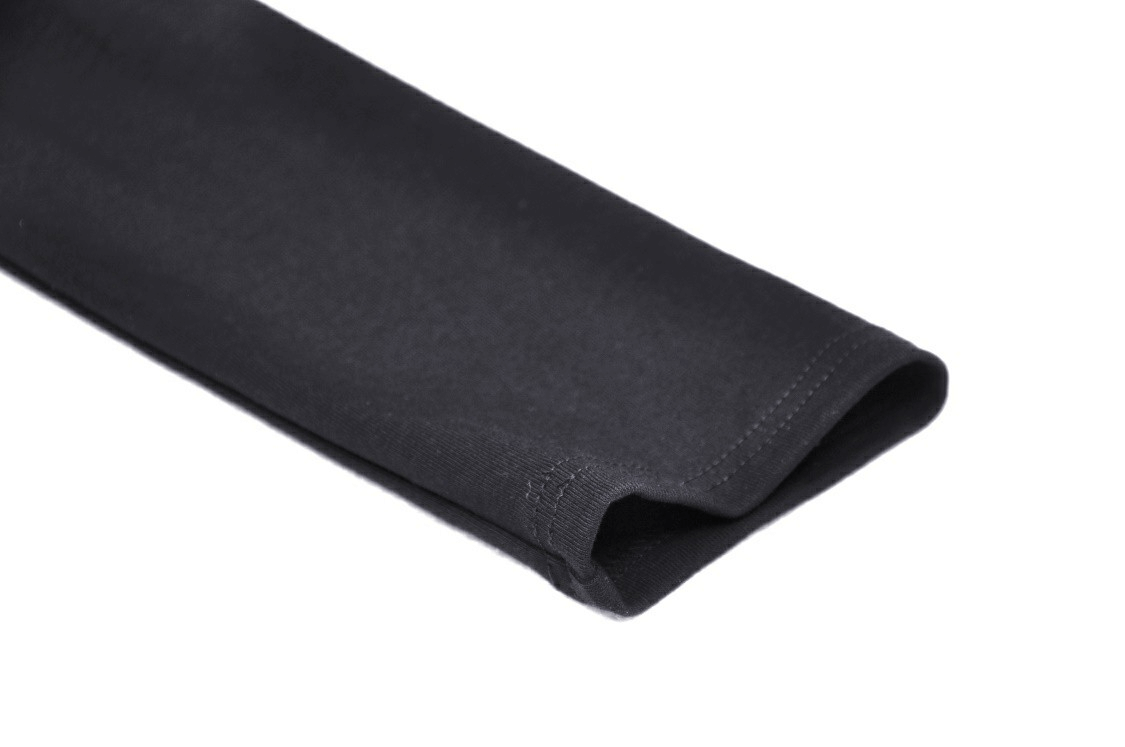 Close-up of black long sleeve fabric, showcasing soft texture and clean stitching for a stylish mesh crop top.