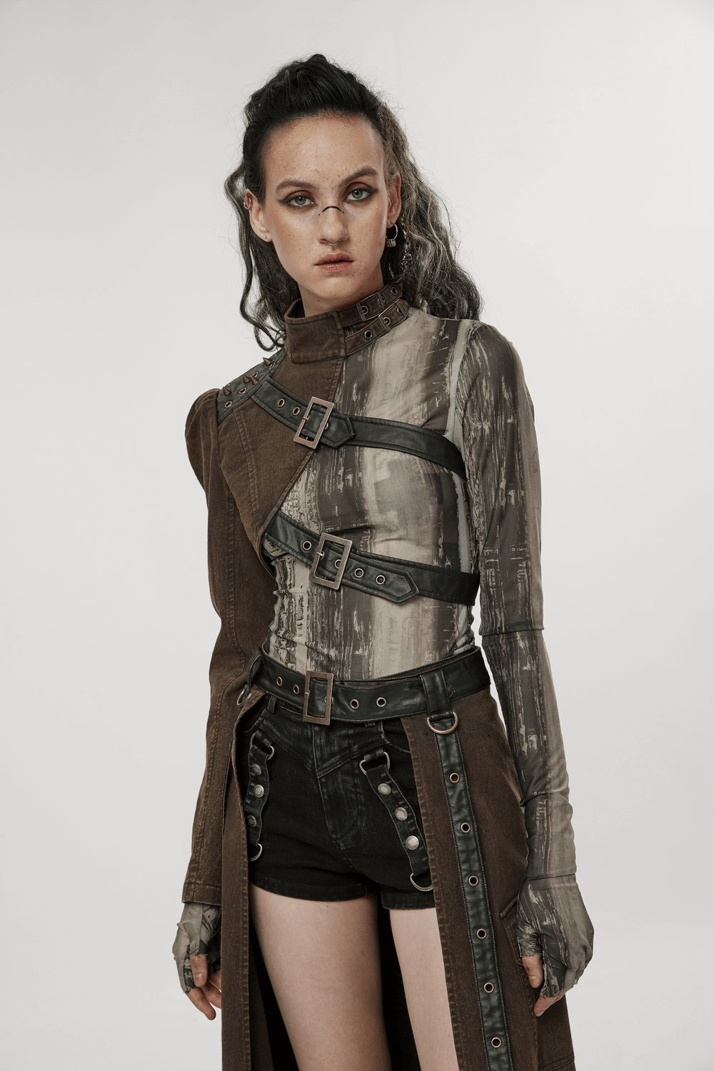 Model showcasing a stylish punk asymmetrical jacket with faux leather and edgy design features in a modern photoshoot.