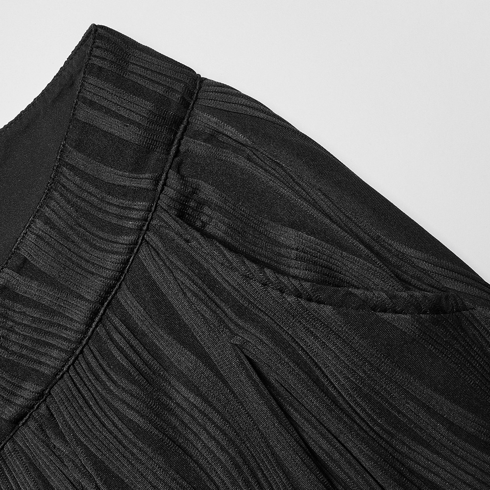 Close-up of stylish black asymmetrical waistband with unique texture and pocket detail for wide leg pants.