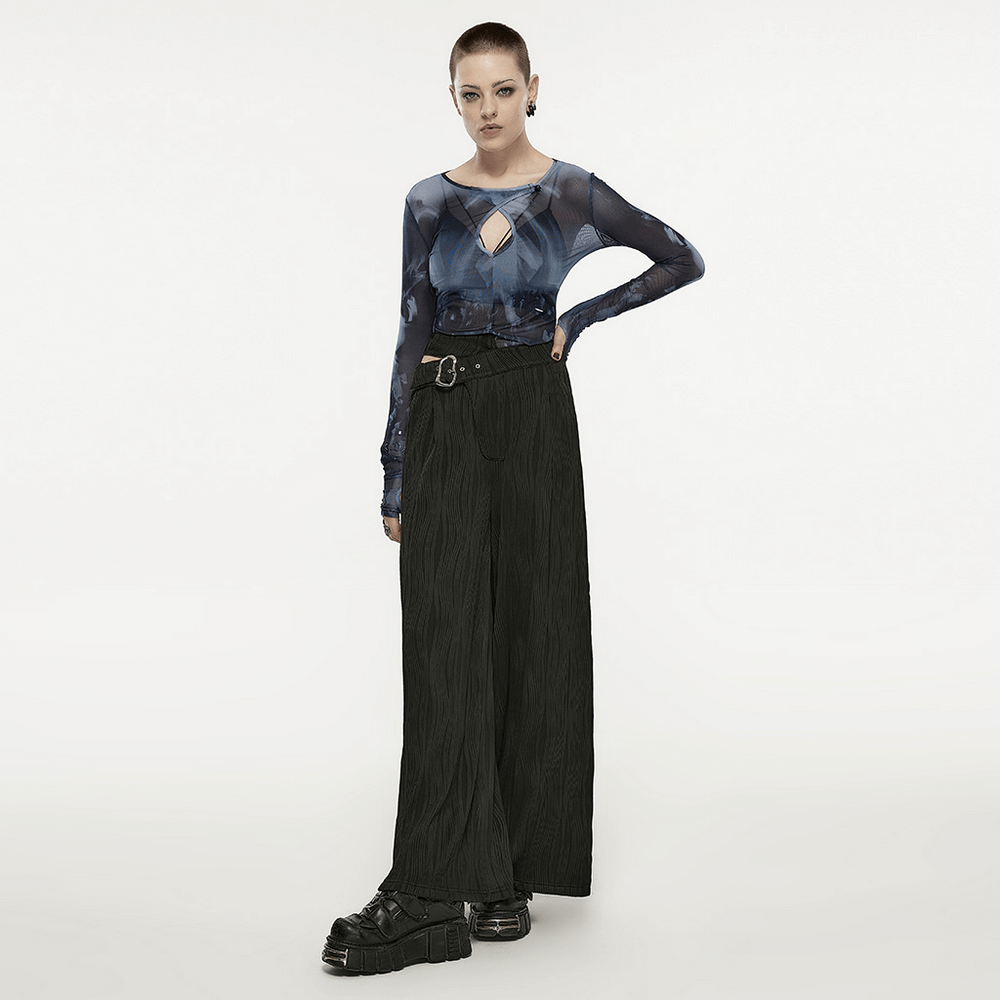 Model showcasing stylish punk black asymmetrical buckle wide leg pants with edgy top and platform shoes.