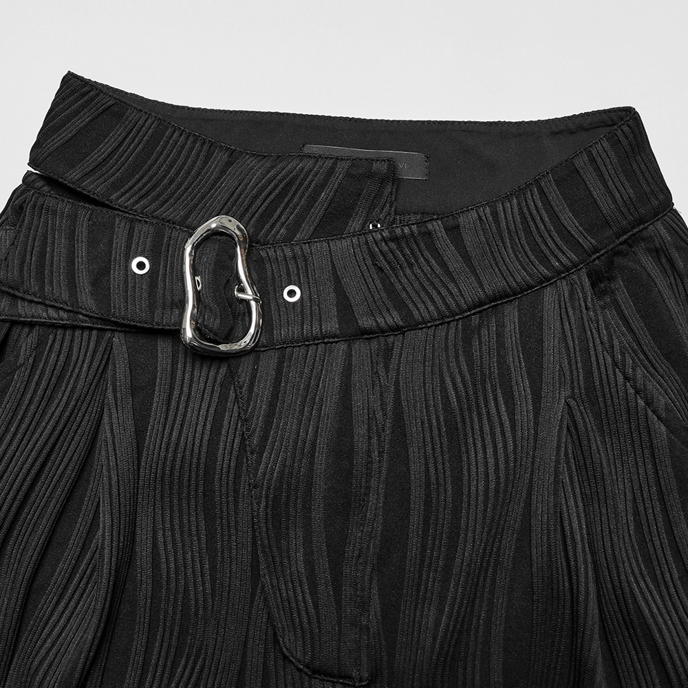 Close-up of stylish black asymmetrical buckle pants showcasing unique waistband design and texture.