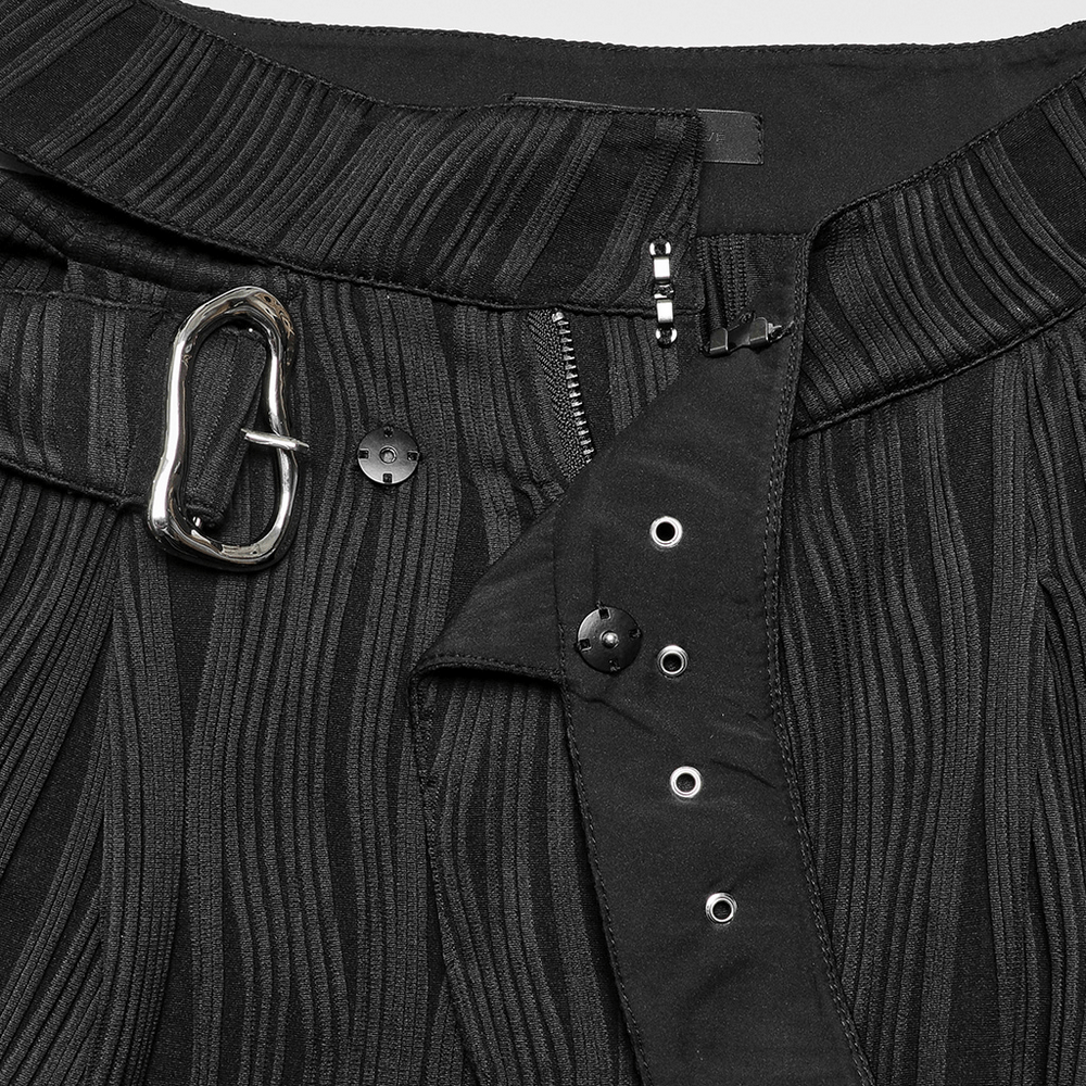 Close-up of stylish black wide leg pants featuring an asymmetrical waistband and metal buckle detail.