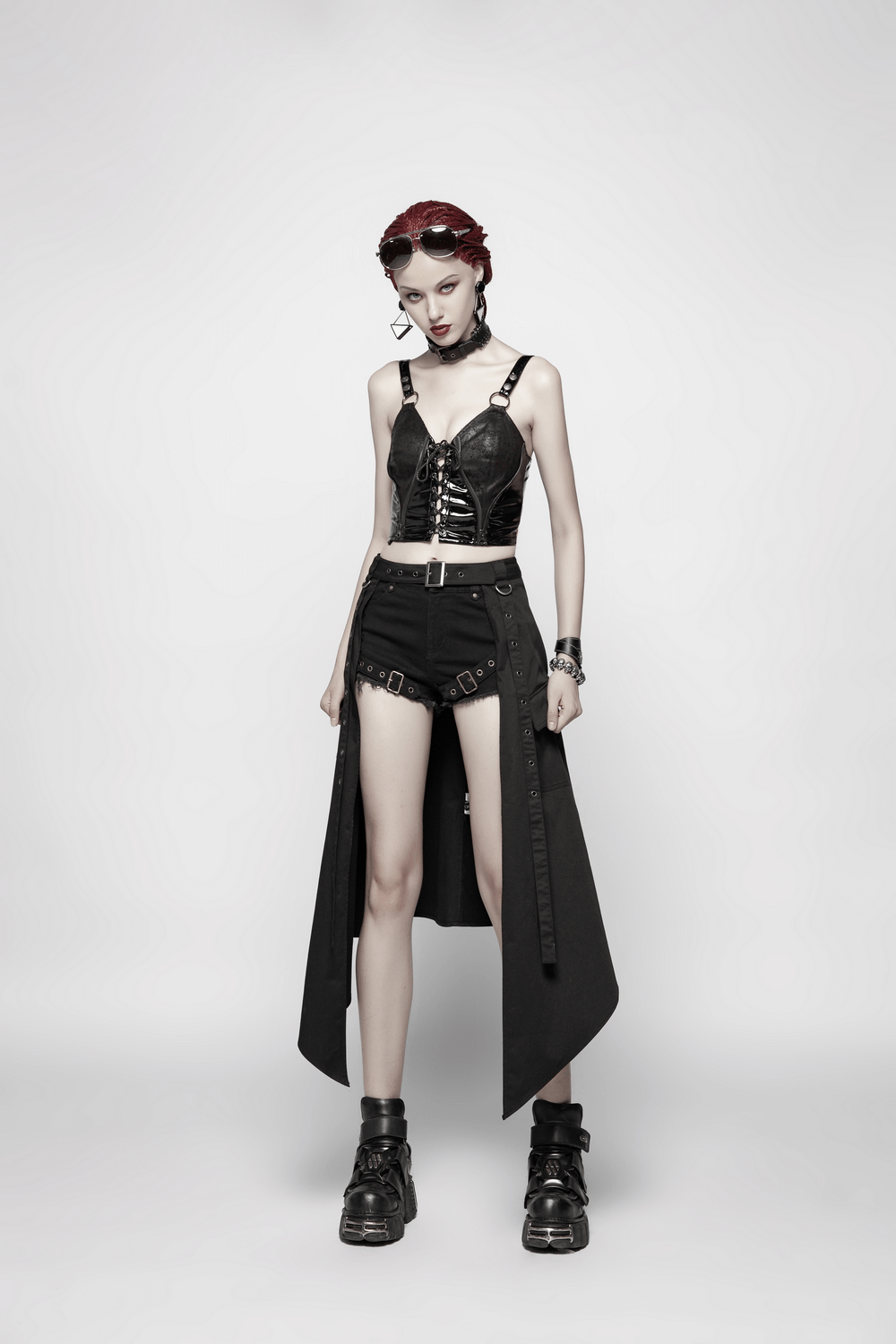 Model showcasing a stylish punk black asymmetrical cargo mini skirt with edgy accessories and boots.
