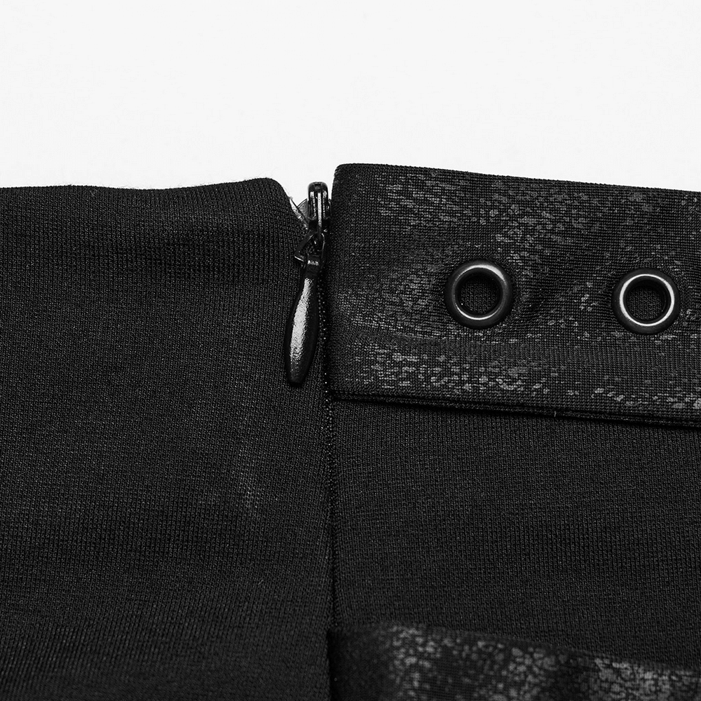 Close-up of the zipper and eyelets on a stylish black long split skirt with fringe.
