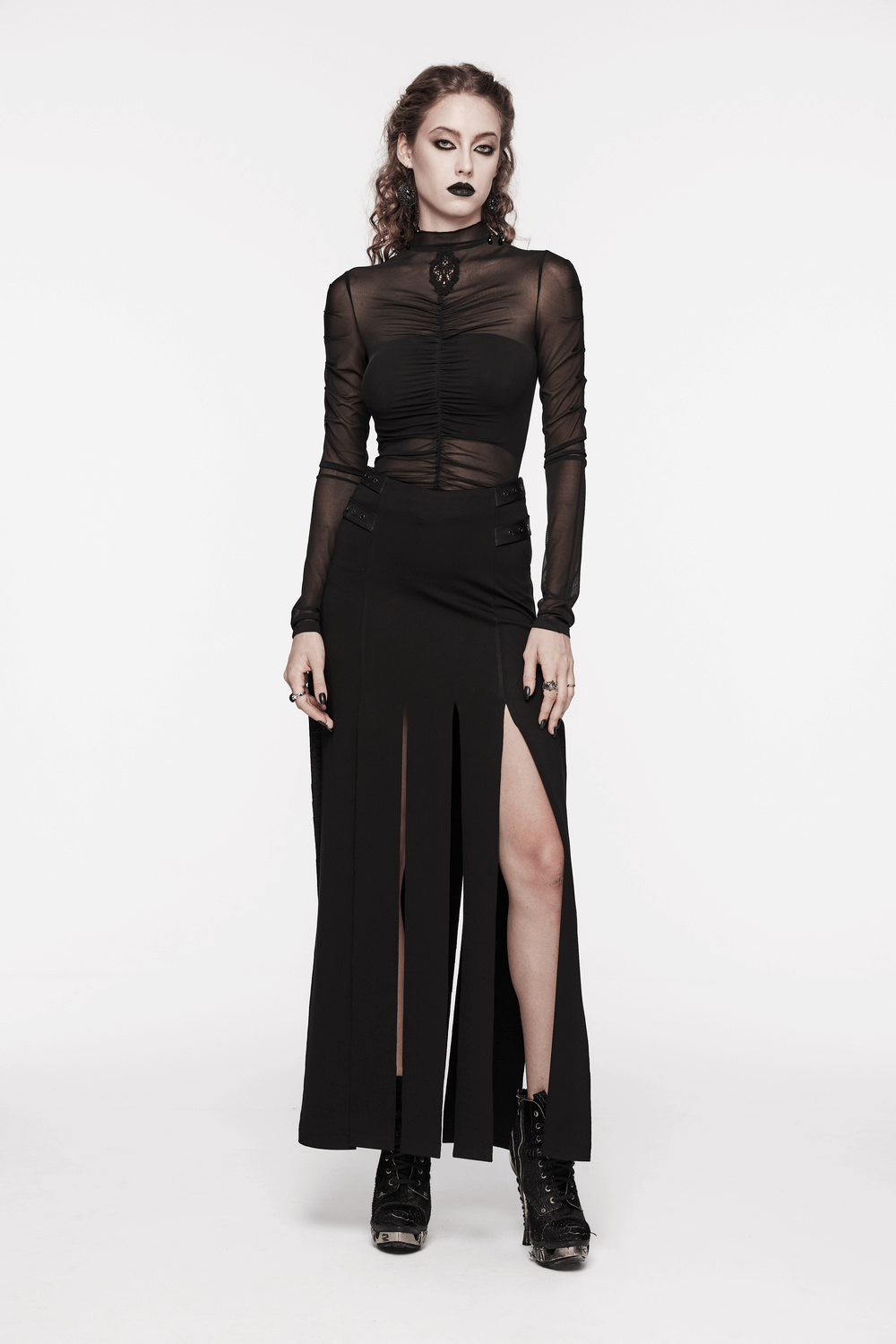 Stylish black long split skirt with fringe and pockets, perfect for an edgy punk look, paired with a sheer black top.