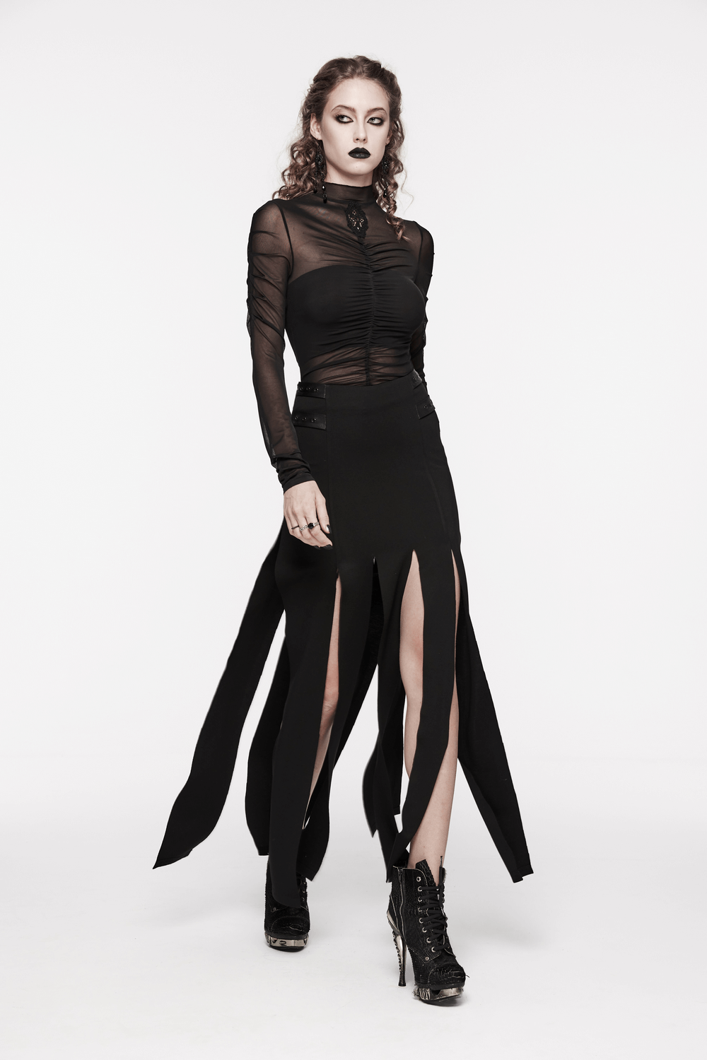 Edgy model wearing a stylish black long split skirt with fringe and a sheer top, perfect for punk fashion enthusiasts.