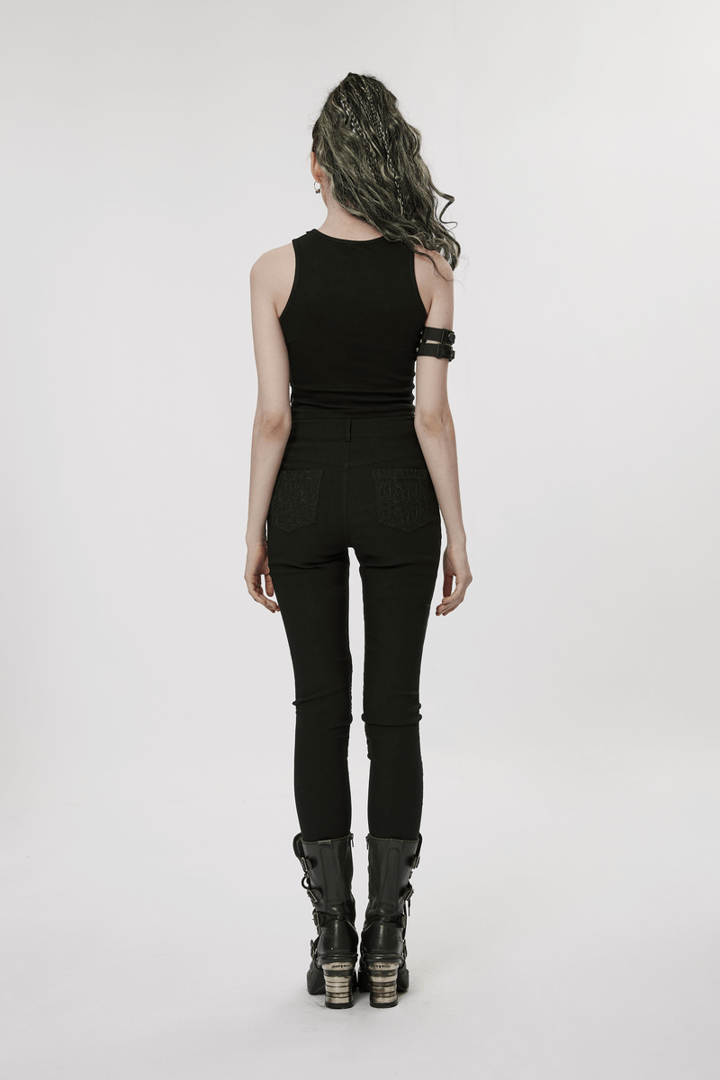 Back view of a model wearing stylish punk black mesh insert buckle skinny pants with a sleeveless top and edgy boots.