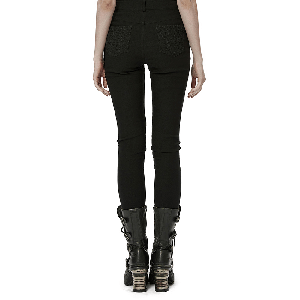 Back view of stylish punk black mesh insert skinny pants with eyelet details and edgy boots.