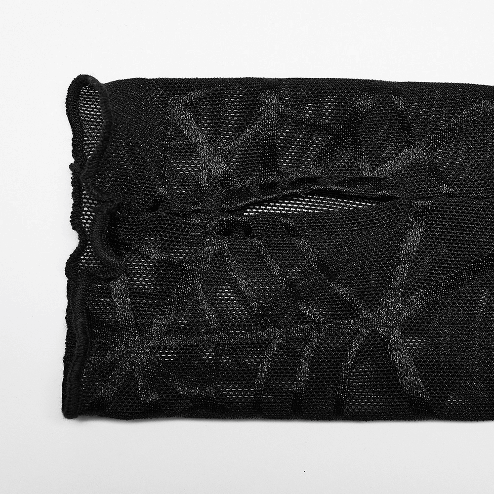 Close-up of black spiderweb mesh fabric with hollow-out design for punk-style clothing.