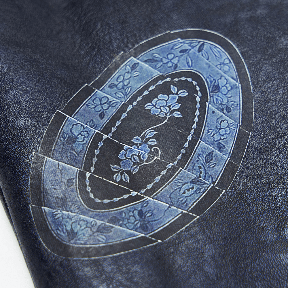 Close-up of floral printed patch on stylish punk cropped leather jacket, showcasing unique patterns and edgy design.