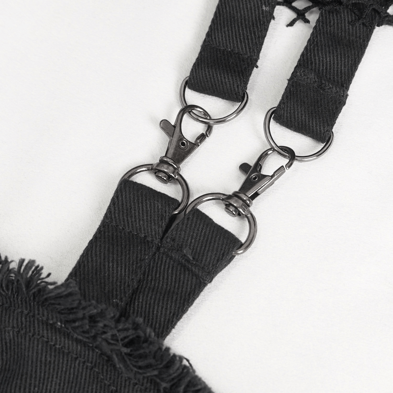 Close-up of detachable clips on black punk-style flared pants, highlighting unique alternative fashion design elements.