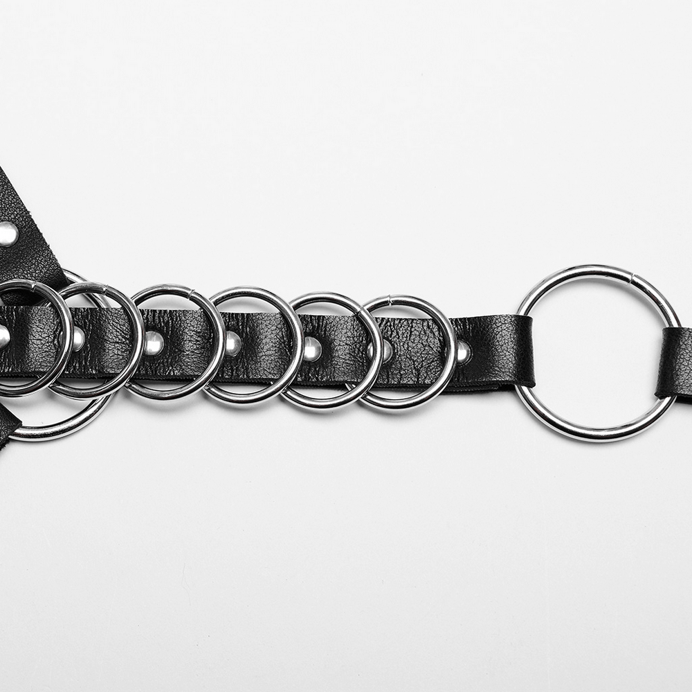 Punk harness detail showing metal rings and durable artificial leather straps in an edgy design.