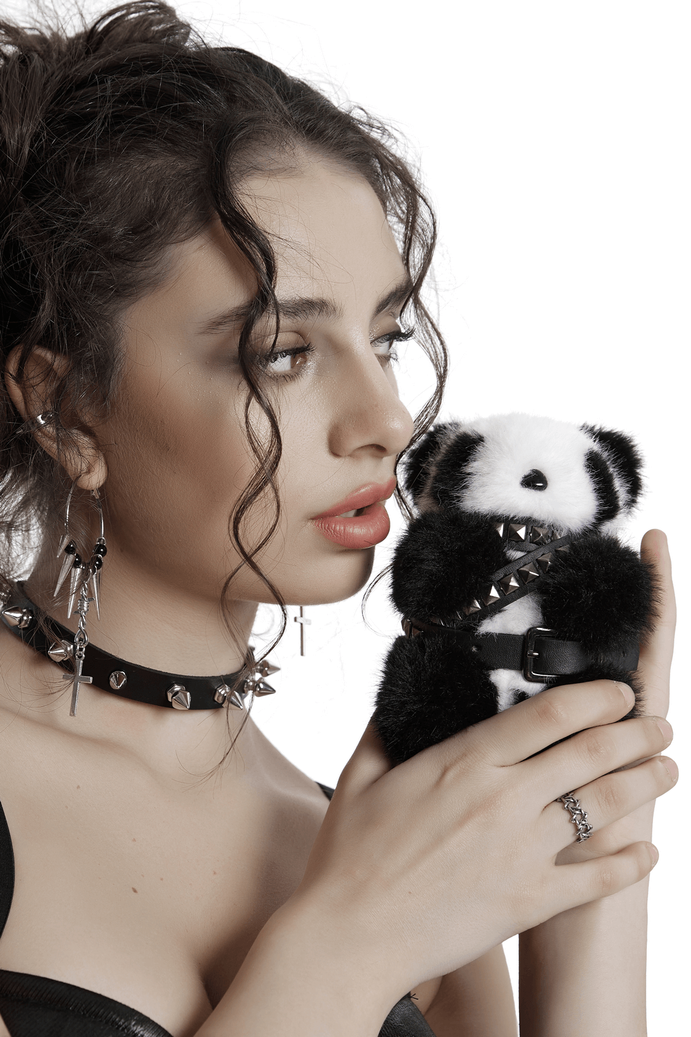 Stylish punk panda faux fur keychain held by a model with trendy accessories, showcasing its edgy design and studded details.