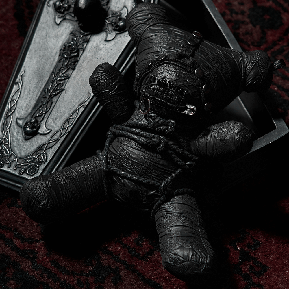Stylish Gothic Taboo Bear plush with black fabric design beside a decorative coffin