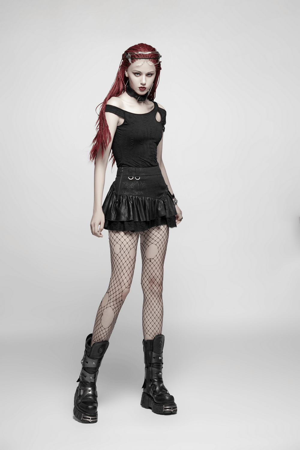 Model wearing a stylish black punk rave mini skirt with ruffles, fishnet stockings, and combat boots.