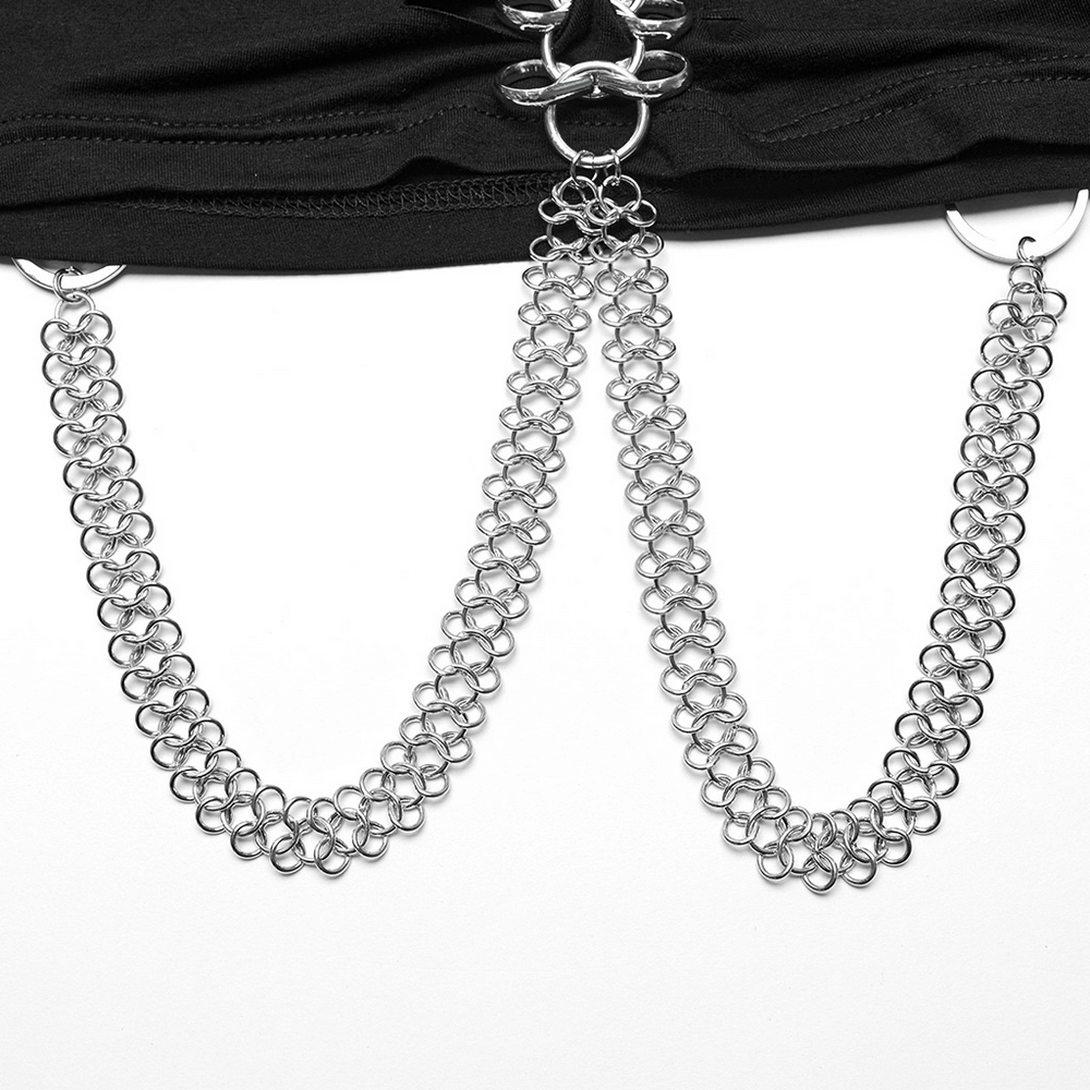 Close-up of stylish silver chain detail on a black punk-rock crop top, featuring unique metal loops.