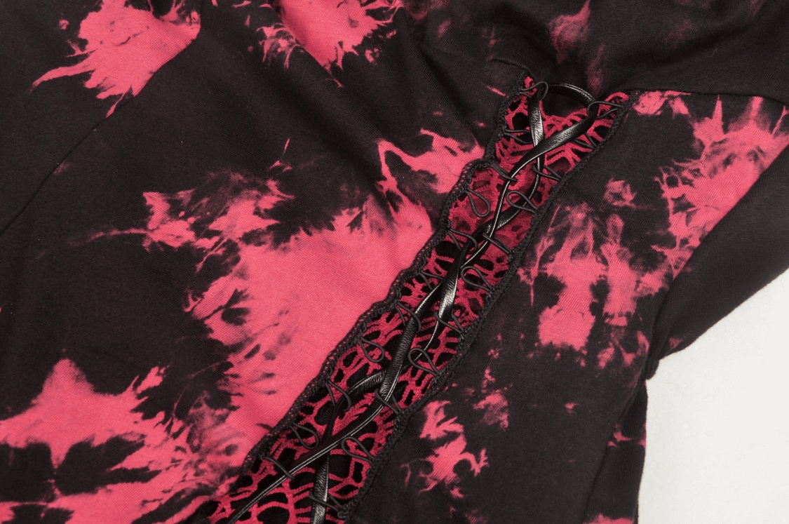 Close-up of stylish punk rock dress with red and black tie-dye pattern and intricate lace detailing.