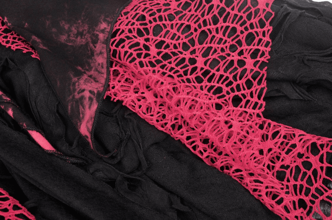 Close-up of black fabric with intricate blood-red mesh detailing, showcasing punk rock design elements.