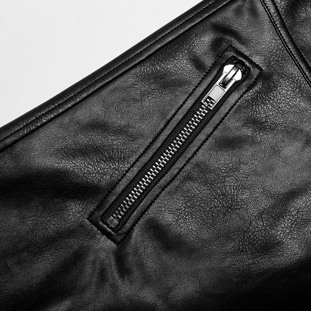 Close-up of stylish punk rock faux leather pants showcasing zipper detail on fabric surface.