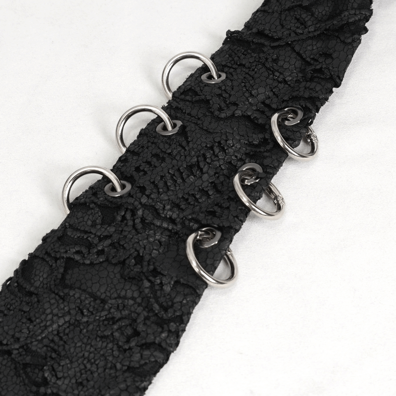 Close-up of black lace tie with metal rings, showcasing a bold punk and gothic style.