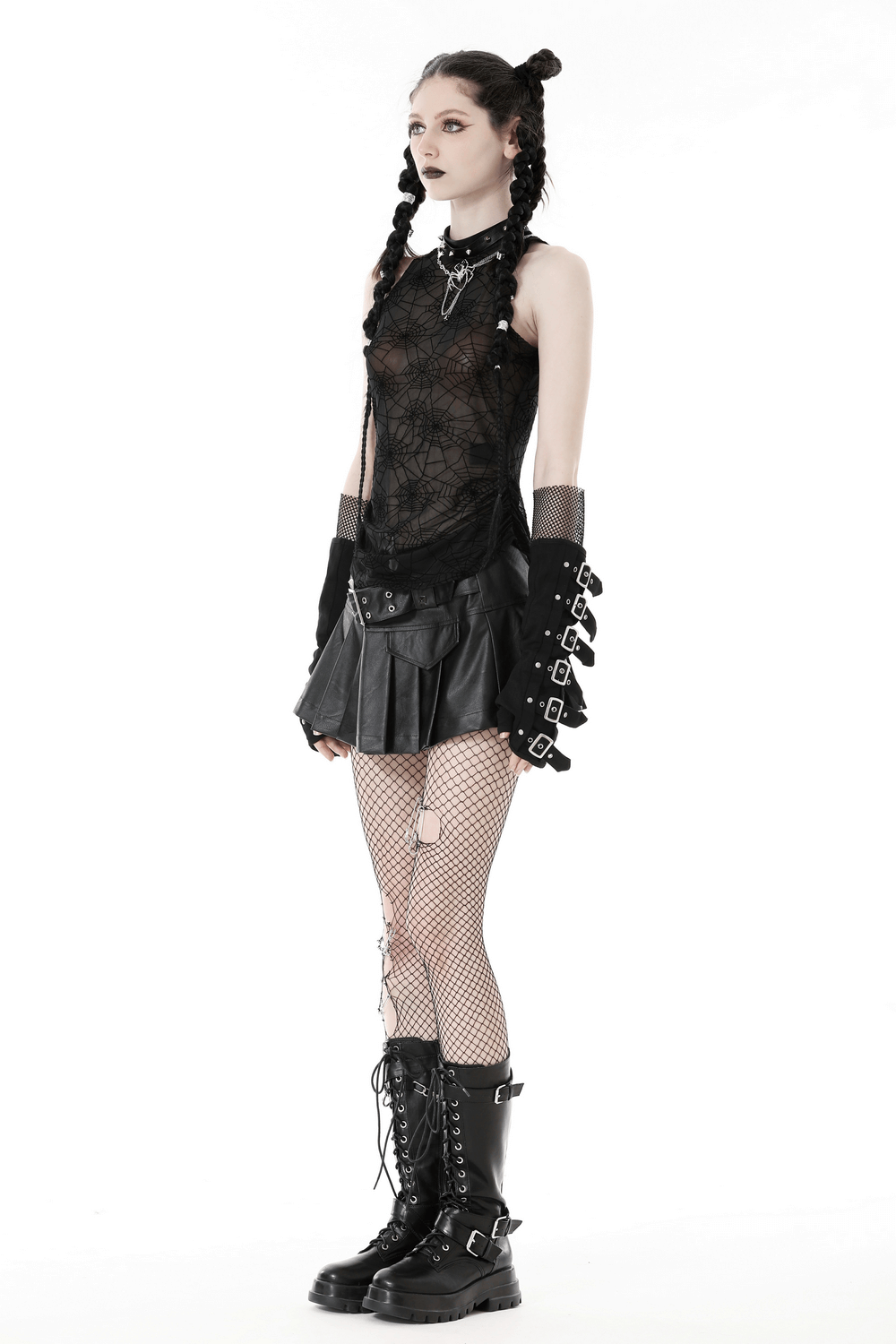 Stylish punk gothic model in spiderweb mesh sleeveless t-shirt and edgy black skirt, showcasing a unique alternative fashion look.