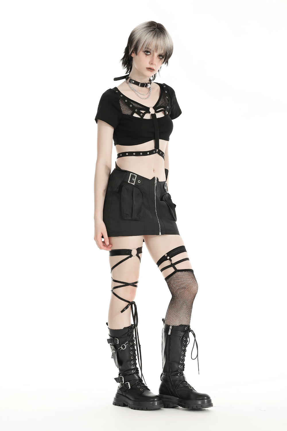 Stylish punk woman in black crop top with metal accents and skirt, ready to make a bold fashion statement.