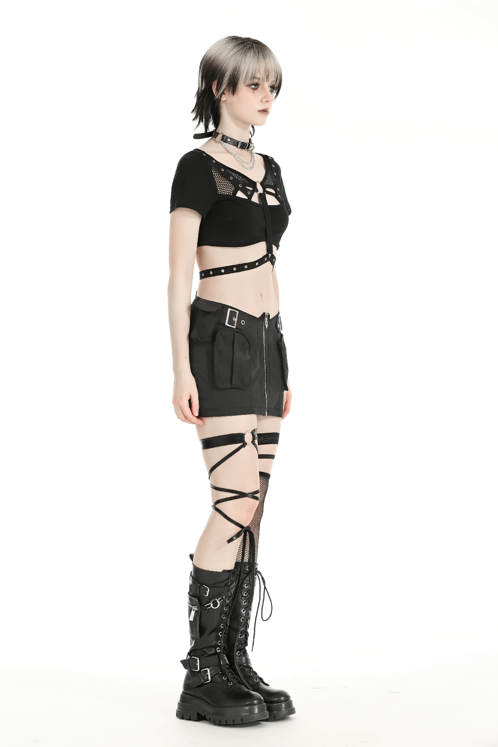 Stylish punk women's crop top with metal accents, paired with a matching skirt and edgy accessories.