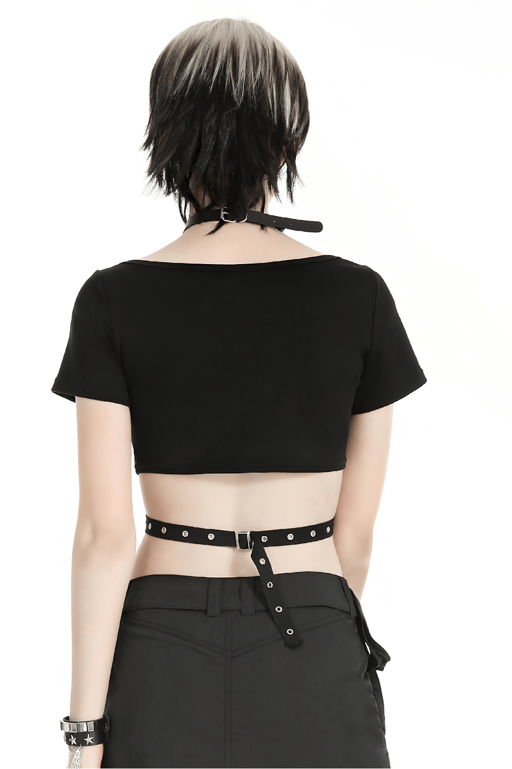 Back view of a stylish women's black crop top with metal accents, perfect for a punk-inspired outfit.