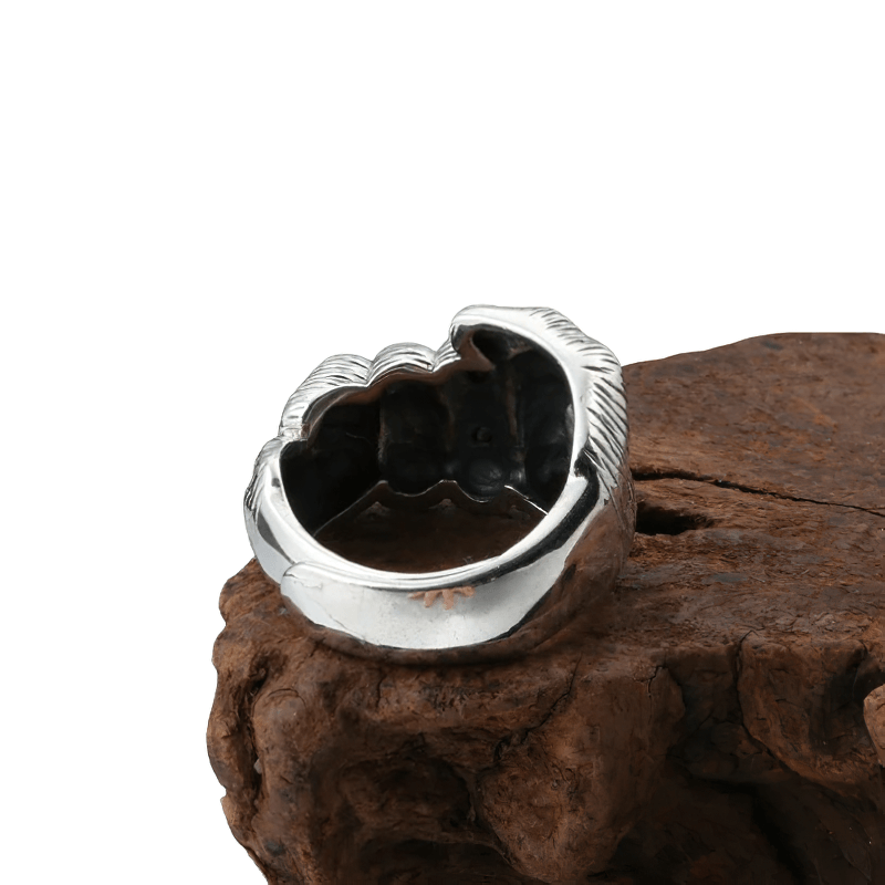 Unisex sterling silver fist-shaped ring showcased on wood, stylish casual jewelry for men and women.
