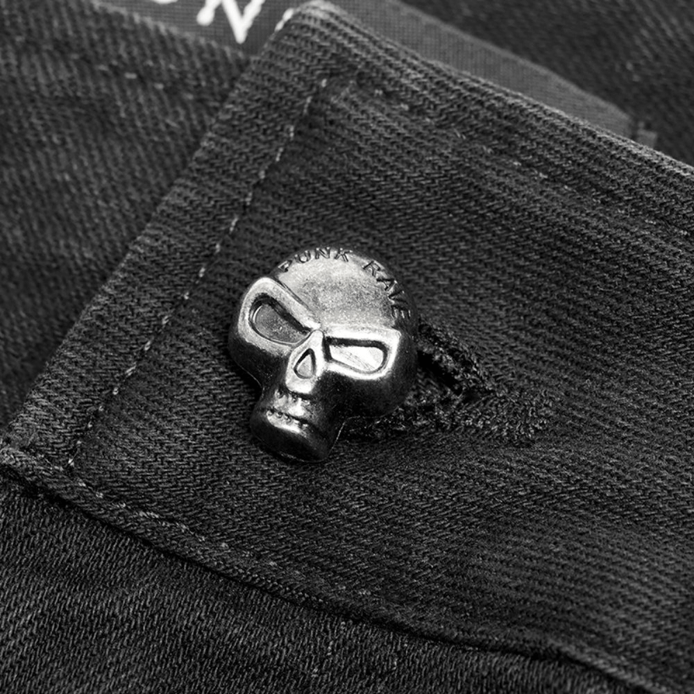 Close-up of stylish black cargo pants featuring a punk-inspired skull button detail for edgy fashion.