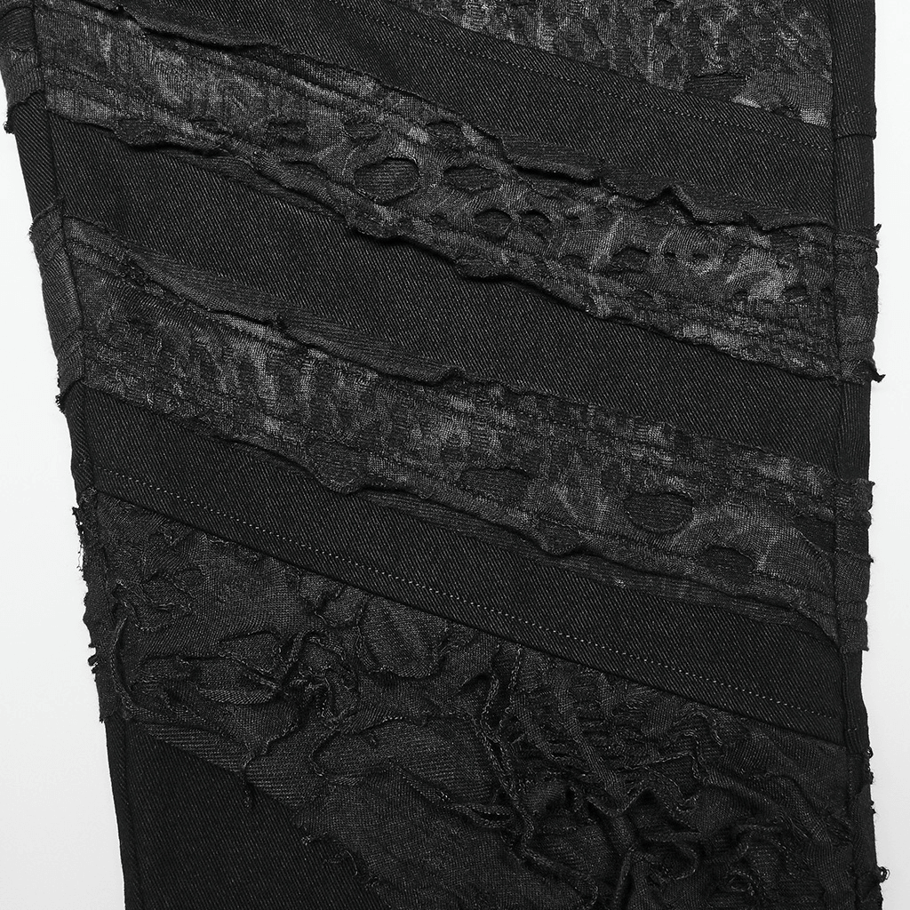Close-up of stylish ripped black gothic trousers showcasing edgy textured design and distressed knit fabric.