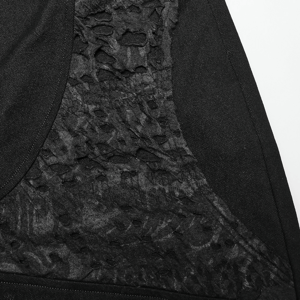 Close-up of stylish ripped knit black gothic trousers showcasing edgy textured design.
