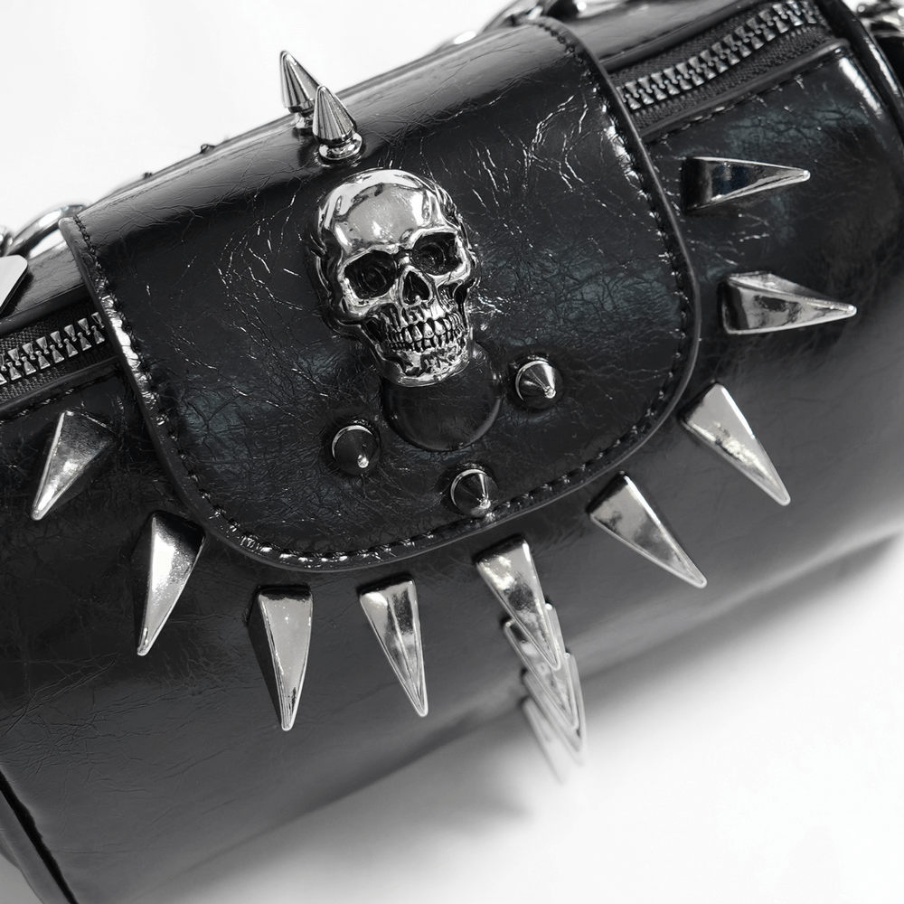 Black leather handbag with silver skull and spike accents, perfect for edgy fashion statements.