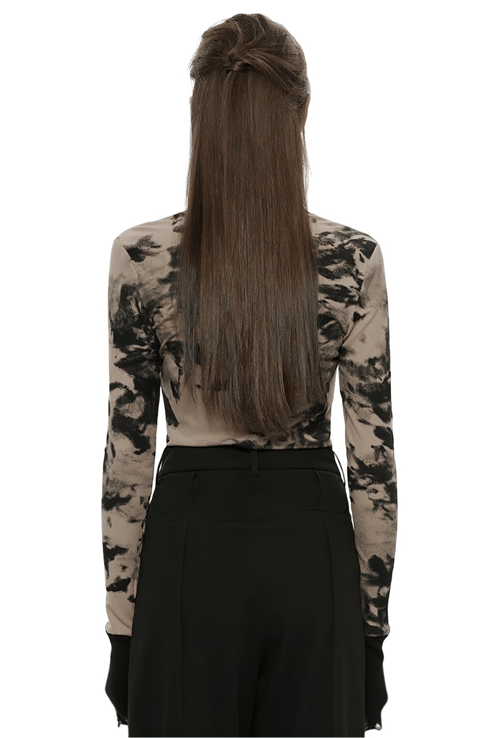 Back view of a stylish tie dye turtleneck top with ripped cuffs, paired with black pants and long hair.