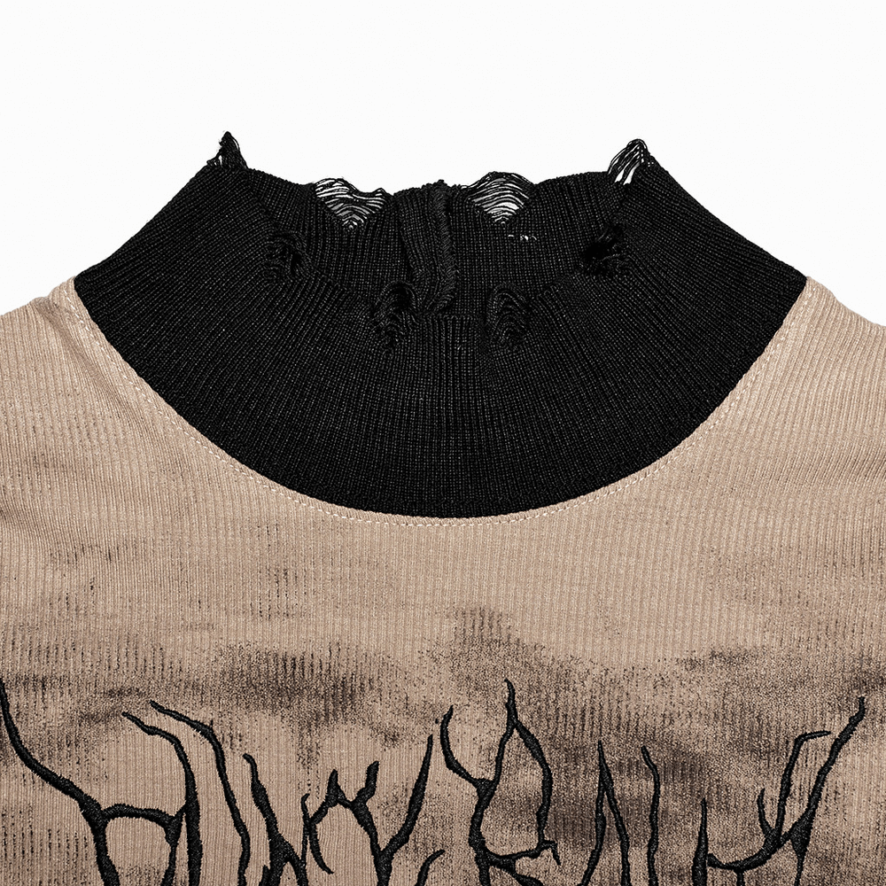 Close-up of a stylish tie dye turtleneck top with ripped black cuffs, featuring unique embroidery details.