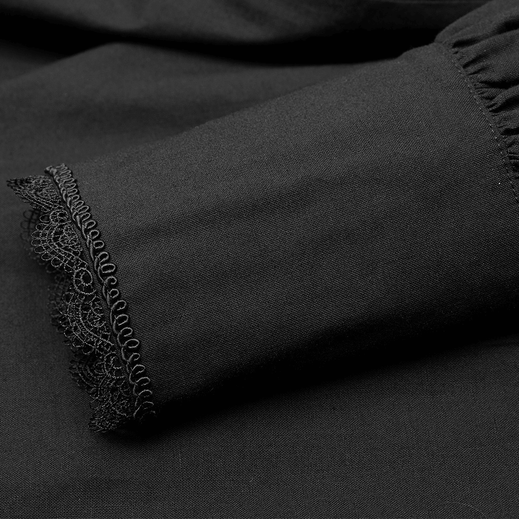Close-up of elegant black cotton shirt sleeve with intricate lace trim, showcasing gothic Victorian style.