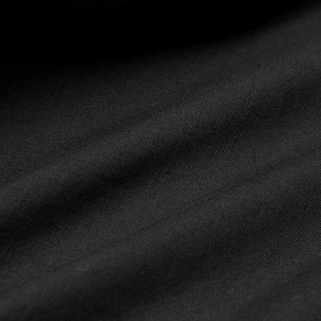 Close-up of elegant black cotton fabric showcasing soft texture and rich depth for fashion designs.