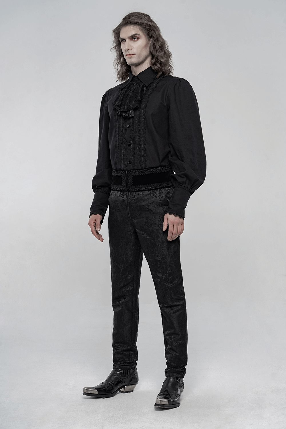 Stylish man in elegant black Victorian ruffle front long sleeve shirt and tailored pants, showcasing gothic fashion.