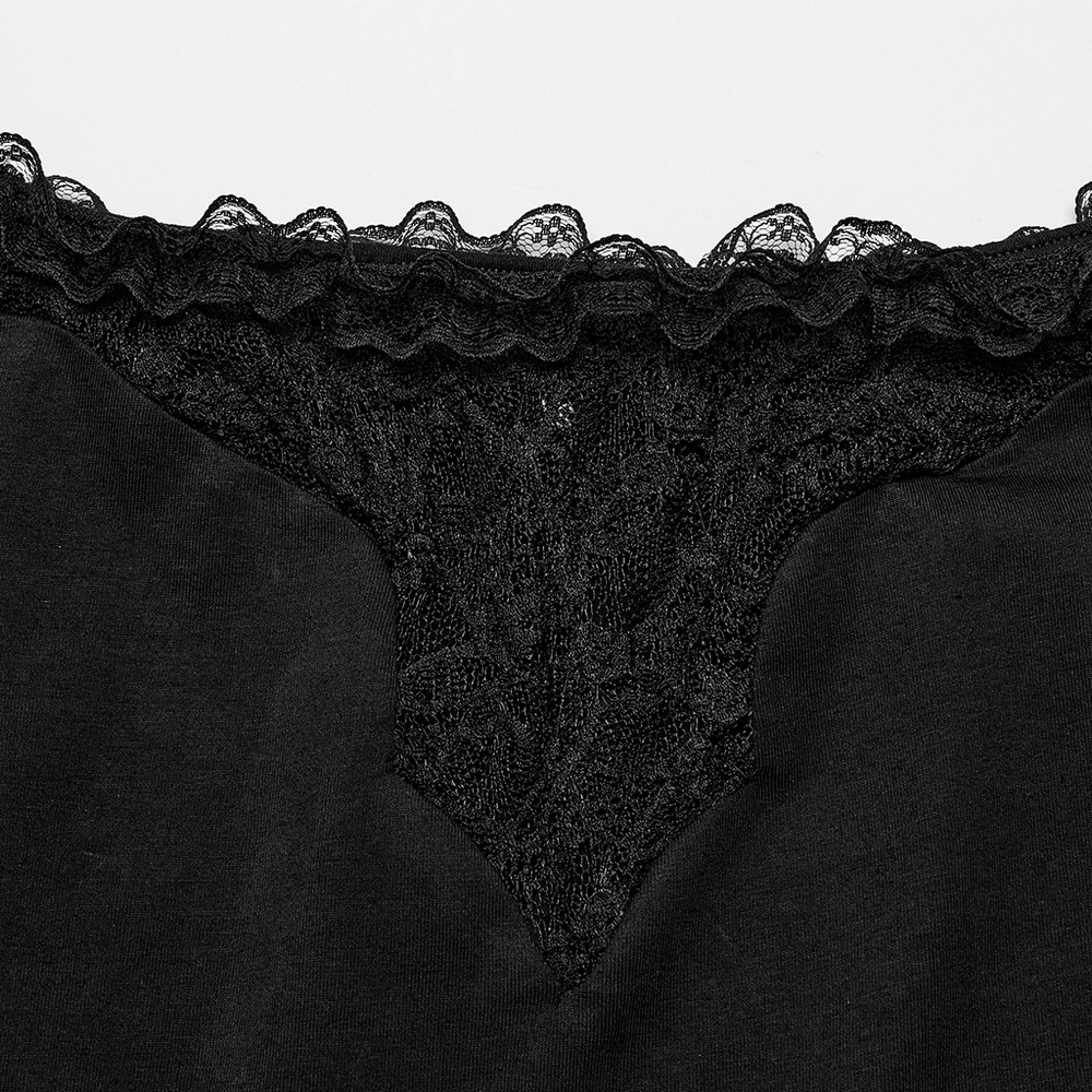 Close-up of black sheer lace detailing on an off-the-shoulder top, showcasing elegant embellishments.