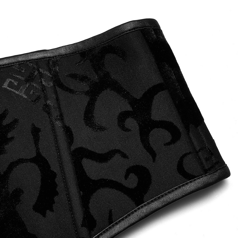 Close-up of a stylish black corset belt with intricate dragon print patterns for a gothic-inspired look.