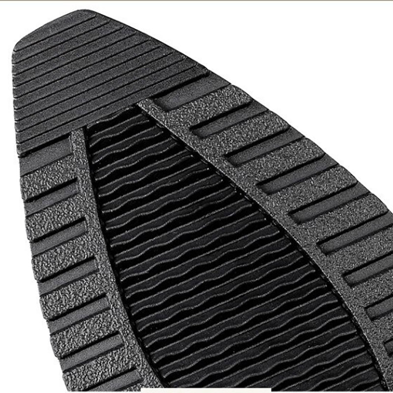 Close-up of the textured sole of stylish women's boots, showcasing durability and grip for goth/rock fashion.