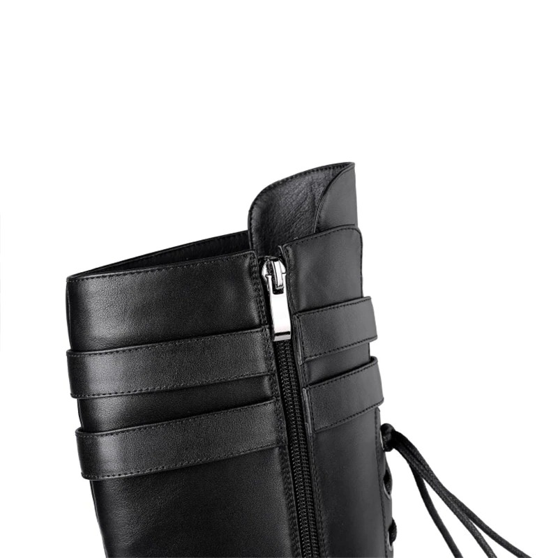 Close-up of stylish black leather women's boots featuring a zipper and lace details, perfect for goth/rock style.