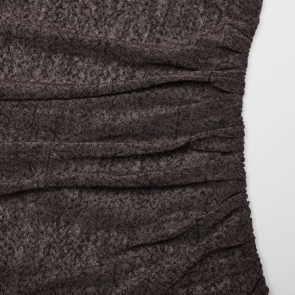 Close-up of dark, textured fabric with subtle layering details from a stylish women's gothic dress.